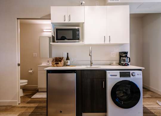 A small kitchen with a washer and dryer built in.