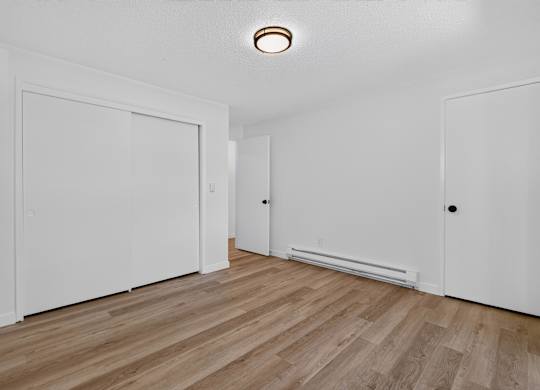 A room with a wooden floor and white walls.