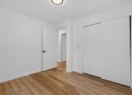 A white door is on the left side of the room.