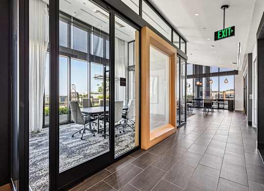 A modern office space with a view of the outdoors through large windows.