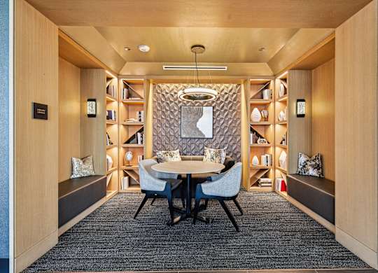 A modern dining room with a round table and chairs.