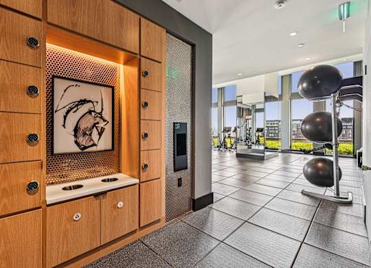 A modern kitchen with wooden cabinets and a fridge.