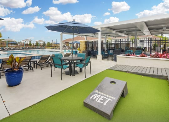 Patio with Tables and Chairs at The Met Apartment Homes, Hattiesburg, MS