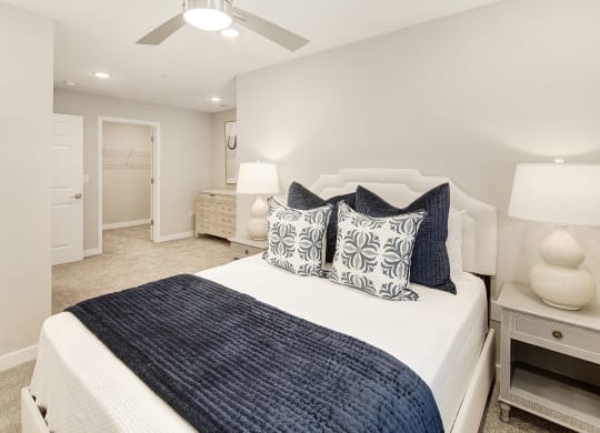a bedroom with a large bed and a ceiling fan at The Azul Apartment Homes, Oxford, Mississippi