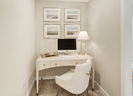 a home office with a computer desk and a white chair at The Azul Apartment Homes in Mississippi 38655