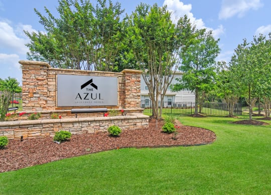 monument sign with trees and grass at The Azul Apartment Homes in Oxford, Mississippi 38655