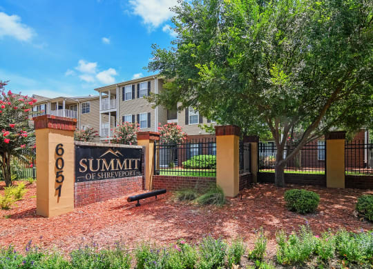 an apartment building with a sign for summit at Summit of Shreveport Apartments, Louisiana