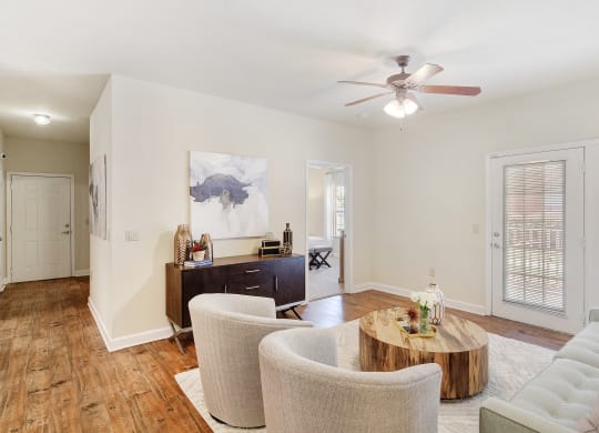 a living room with furniture and a ceiling fan at Summit of Shreveport Apartments, Shreveport