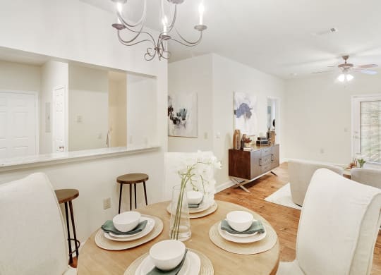a living room and dining room with a table and chairs at Summit of Shreveport Apartments, Shreveport, 71105