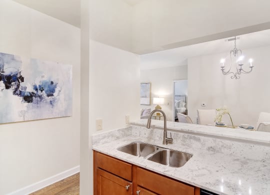 a kitchen with granite counter tops and a sink at Summit of Shreveport Apartments, Shreveport, LA