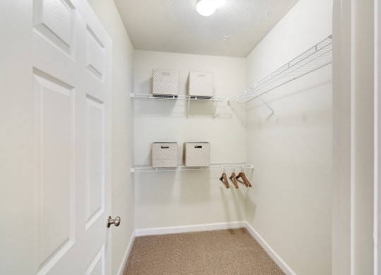 a walk in closet with shelves and shoes on the wall at Summit of Shreveport Apartments, Shreveport, LA, 71105