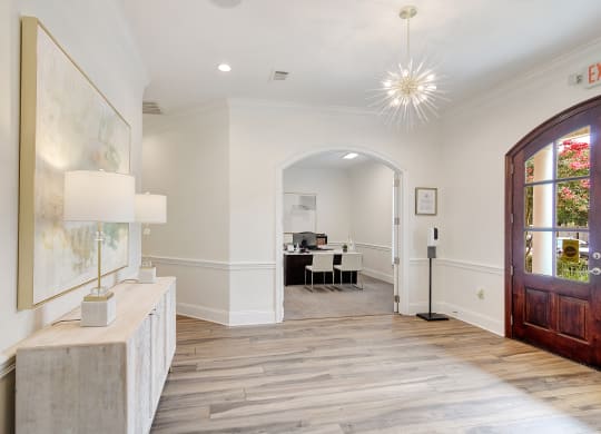a living room with a wood floor and a wooden door at Summit of Shreveport Apartments, Shreveport, LA, 71105