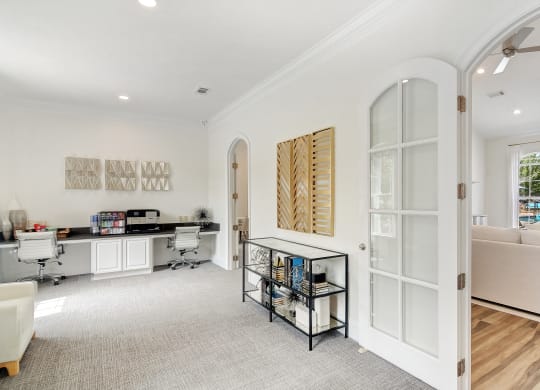 a living room with white walls and a glass door at Summit of Shreveport Apartments, Louisiana