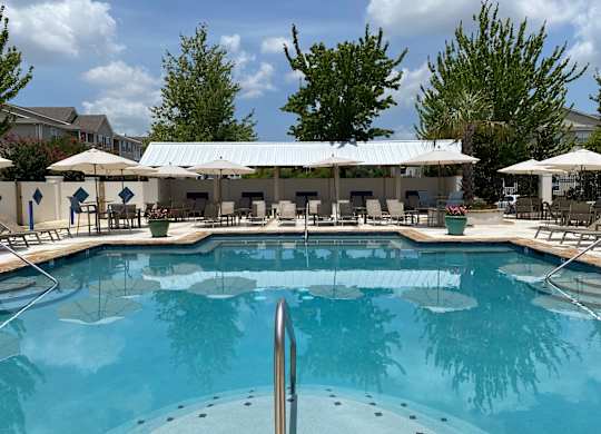 A large swimming pool with a metal ladder in the middle.