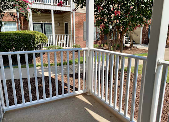 A white railing in front of a house.
