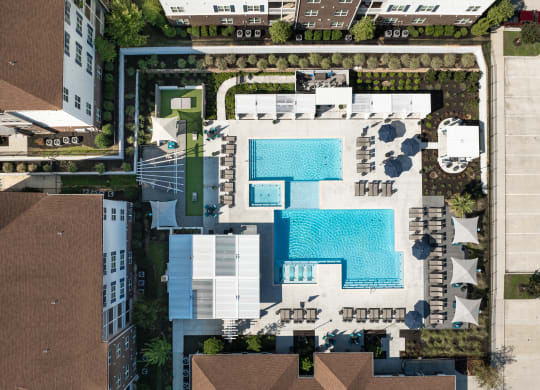 arial view of a swimming pool on the roof of a building at The Met Apartment Homes, Hattiesburg, Mississippi