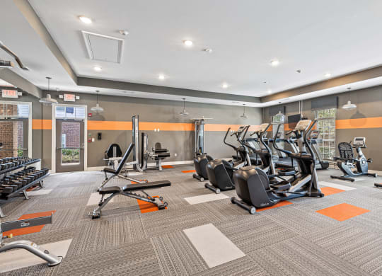 a gym with cardio equipment and weights at the apartments at The Met Apartment Homes, Mississippi