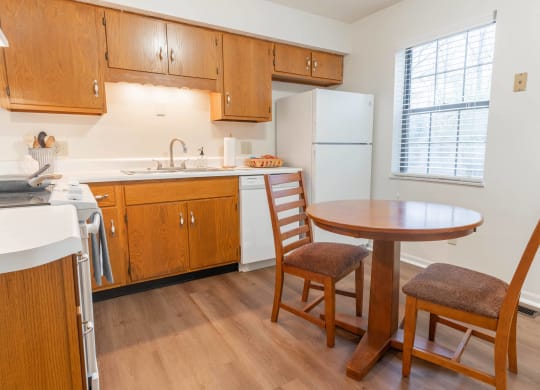 a kitchen with a table and two chairs
