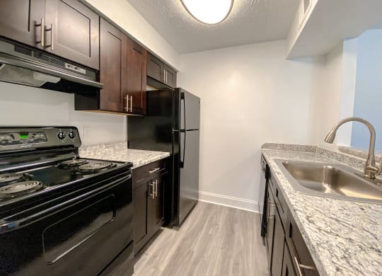 Spacious kitchen with wood style plank flooring at Camelot East Apartments, Fairfield, Ohio