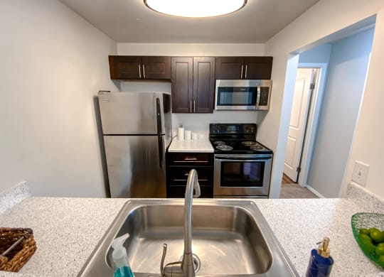Modern kitchen with stainless steel appliances at Camelot East Apartments, Ohio