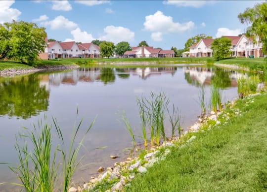 Large, beautiful lake with lush natural surrounding at Waterstone Place Apartments in Indianapolis, IN