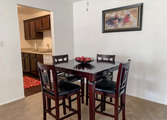 Spacious dining room open to the living room at The Lodge Apartments in Indianapolis, IN