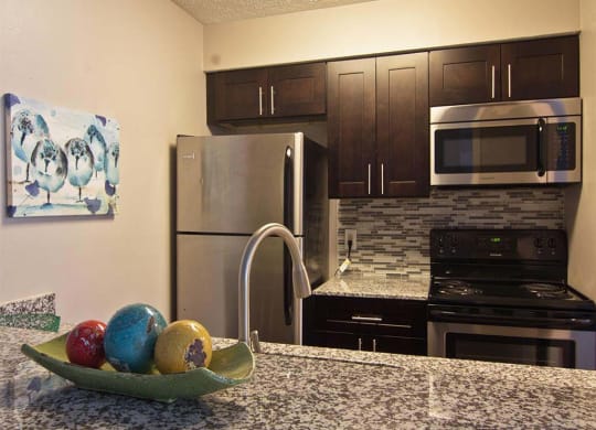 Modern kitchen with stainless steel appliances at Camelot East Apartments, Fairfield, 45014