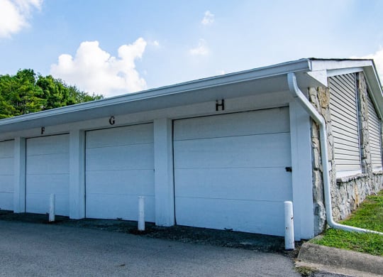 a white garage with a blue roof