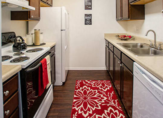 Kitchen with White Cabinetry and Appliances at The Lodge Apartments, Indianapolis