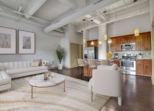 a living room with a white couch and a table at 100 South Apartments, Buffalo, NY 14202