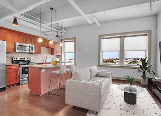 A modern kitchen with a white ceiling and a large window. at 100 South Apartments, Buffalo, NY