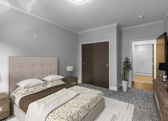 Furnished bedroom with tufted headboard and dark closet doors at Nineteen North Apartments, Buffalo, New York