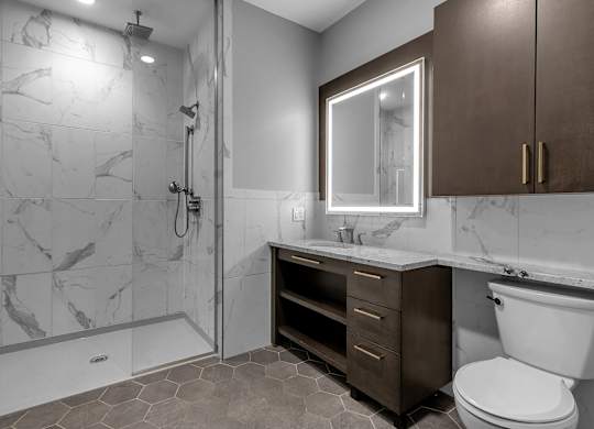 Contemporary bathroom with illuminated mirror and walk-in shower at Nineteen North Apartments, Buffalo