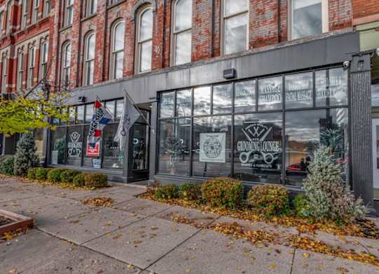 A building with a glass window and a sign that says "Gardening Ace".