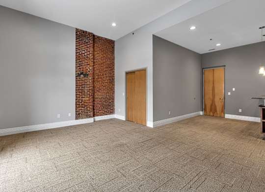 A room with a brick wall and carpeted floor.