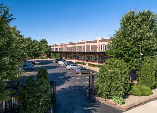 an aerial view of a building with cars parked in a parking lot at The Lofts at Elk Terminal, Buffalo, NY, New York, 14204
