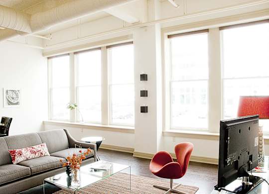 a living with a couch and a television at 100 South Apartments, Buffalo, New York
