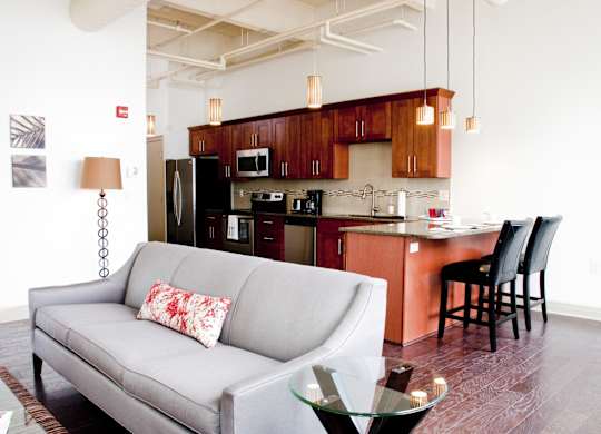 a kitchen and living room with a couch and a table at 100 South Apartments, Buffalo