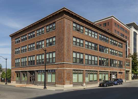 a brick building on the corner of a city street at 100 South Apartments, Buffalo, NY