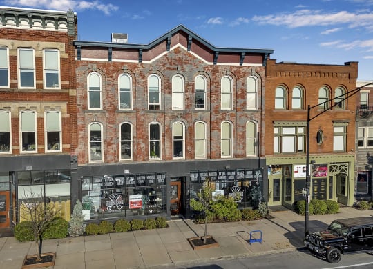 a large brick building on the corner of a city street at The Granite Works Apartments , Buffalo, New York