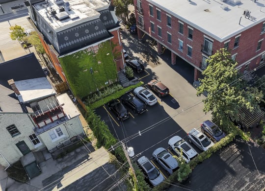 an aerial view of a city street with cars parked in a parking lot at The Granite Works Apartments , Buffalo, NY, 14202