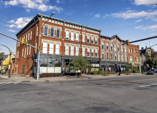a large brick building on the corner of a city street at The Granite Works Apartments , Buffalo, NY