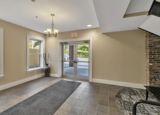 an empty entryway with a brick wall and a glass door at The Granite Works Apartments , Buffalo