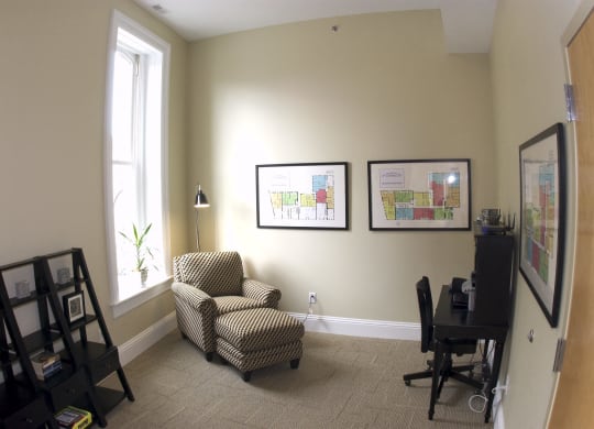 an office with a chair and a desk and a window at The Granite Works Apartments , Buffalo