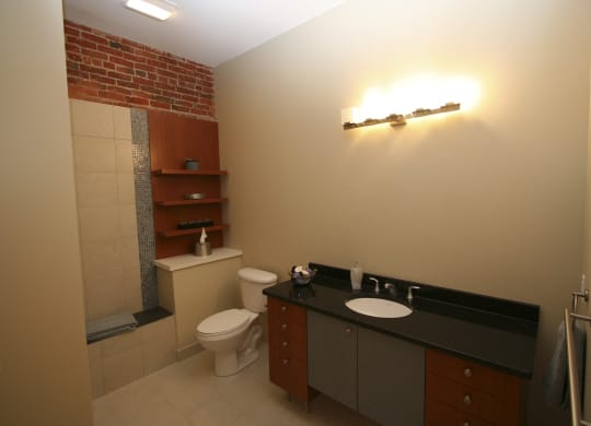 a small bathroom with a toilet and a sink at The Granite Works Apartments , New York