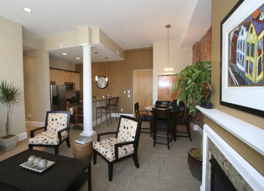 a living room with a table and chairs and a fireplace at The Granite Works Apartments , Buffalo, 14202