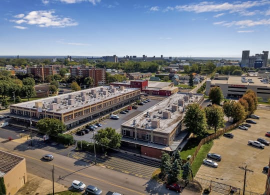 an aerial view of a parking lot and buildings in a city at The Lofts at Elk Terminal, Buffalo, NY