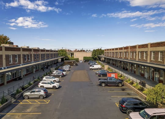 an aerial view of a parking lot with cars and buildings at The Lofts at Elk Terminal, Buffalo, NY, 14204