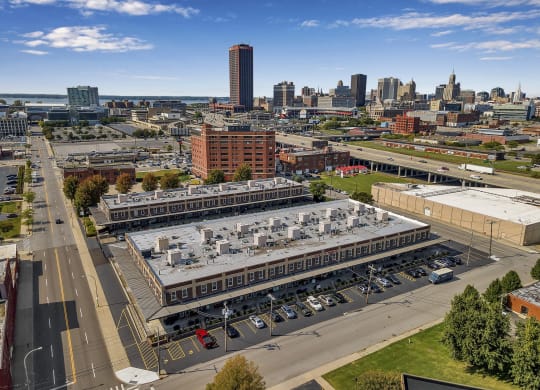 an aerial view of a large building with a city in the background at The Lofts at Elk Terminal, Buffalo, New York