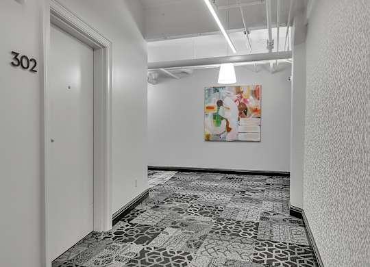 a room with a door and a painting on the wall at 100 South Apartments, Buffalo